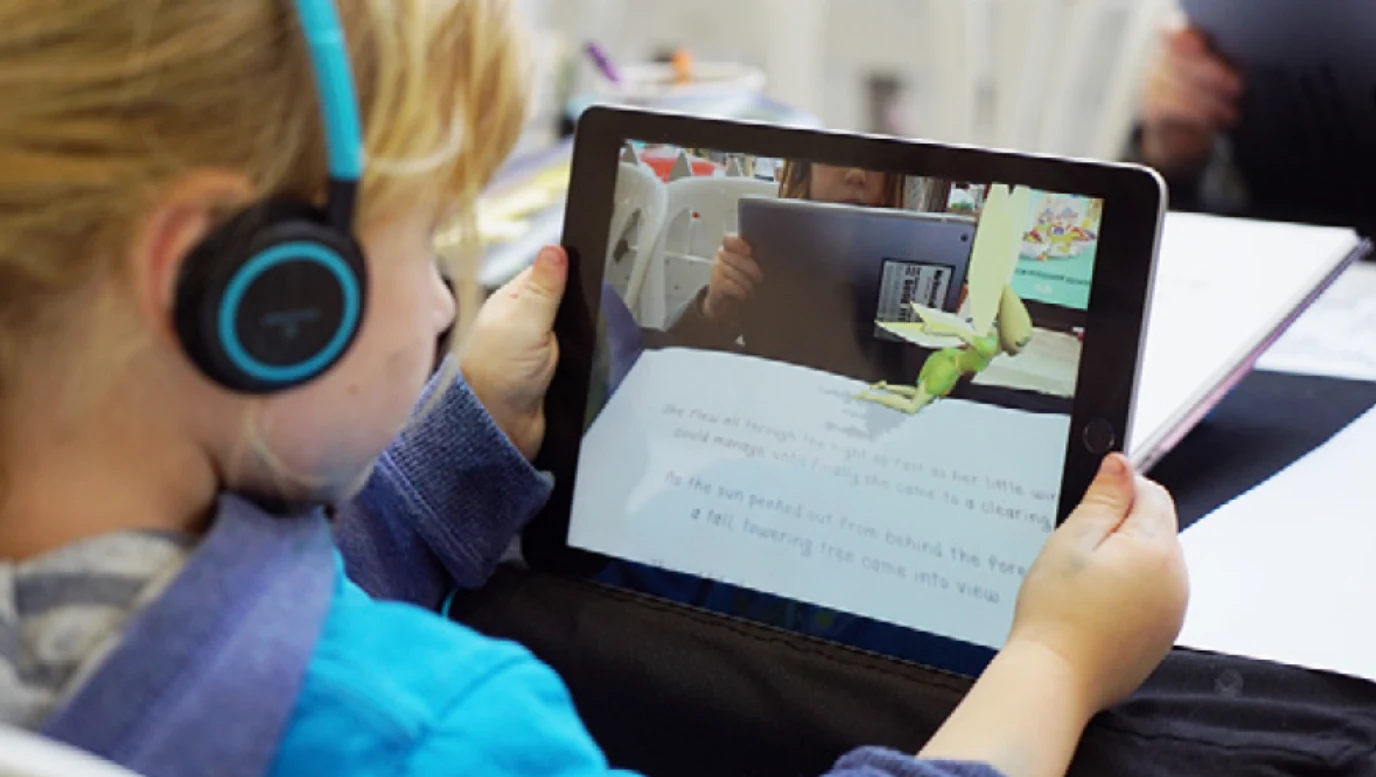 A child explores The Green Fairy AR companion book on a tablet